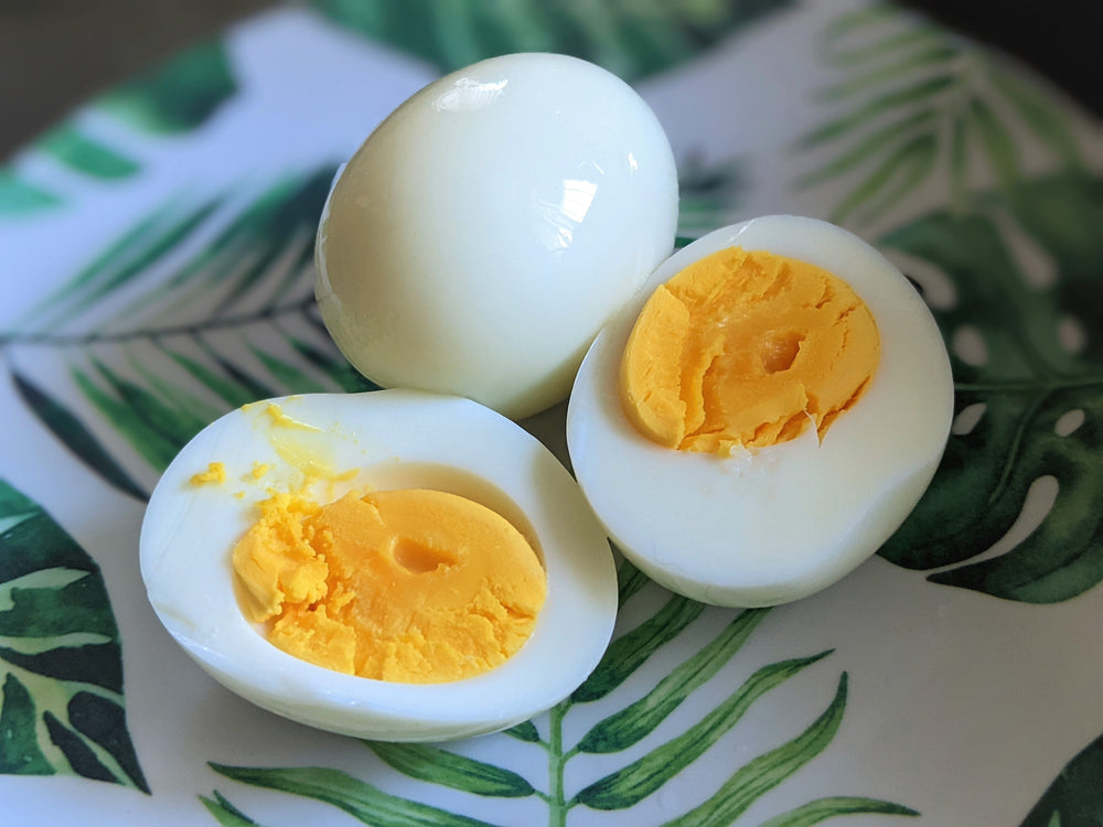 Fresh steamed eggs three eggs served on a white and green leafed plate. National Egg Day Best Eggs at Treats for Chickens Healthy Eggs Organic Eggs Boiled Eggs Streamed Eggs
